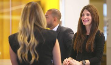 Two women chatting in a meeting room