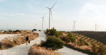 Wind turbines in rural area with people walking